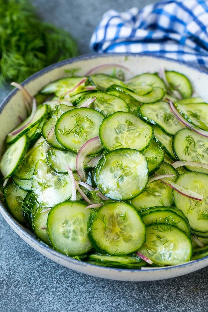 Cucumber Salad Recipe | Cucumber Dill Salad | Cucumber Recipe #cucumbers #salad #glutenfree #sidedish #sadud A bowl of cucumber salad with red onion, thinly sliced cucumbers and chopped dill.