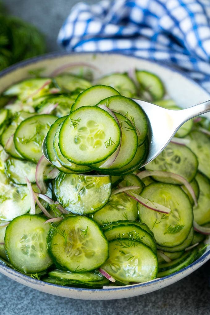 Cucumber Salad Recipe | Cucumber Dill Salad | Cucumber Recipe #cucumbers #salad #glutenfree #sidedish #sadud A spoon serving up a portion of classic cucumber salad.