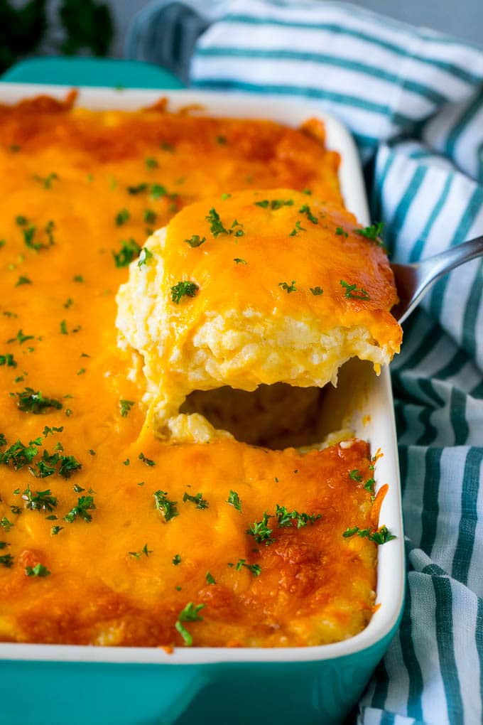 Hash Brown Casserole | Potato Casserole | Hash Brown Side Dish #potatoes #cheese #casserole #sidedish #sadud A spatula pulling out a serving of cheesy hash brown casserole.