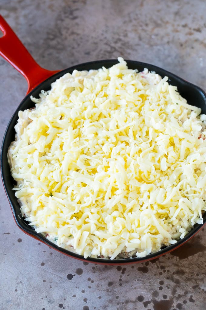 Reuben Dip Recipe | Corned Beef Dip | Cheese Dip #dip #cheese #cornedbeef #appetizer #lowcarb #keto #sadud A skillet of dip topped with shredded cheese.