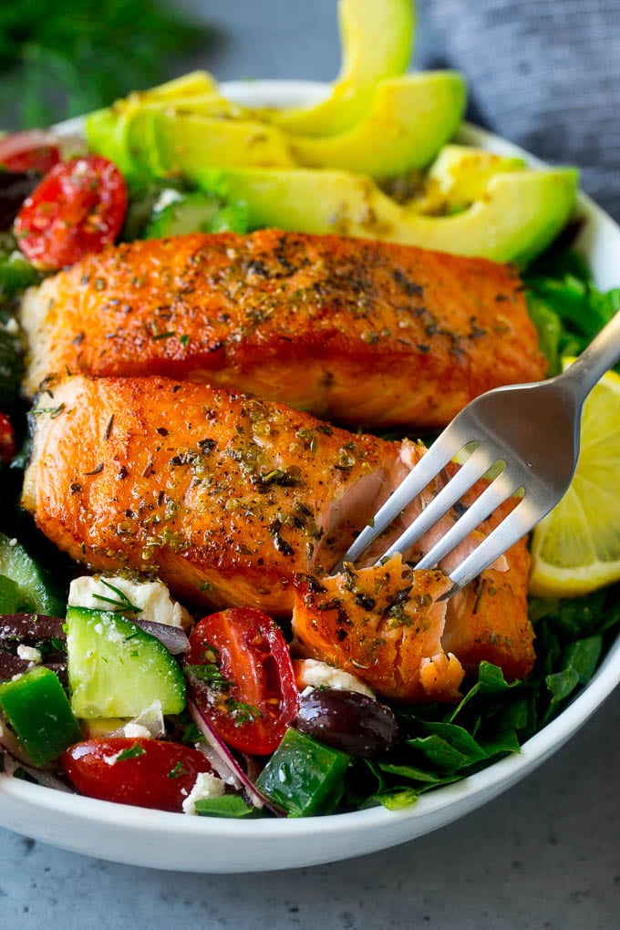 Greek Salmon Salad Recipe | Low Carb Salmon Recipe | Salmon Salad #salmon #seafood #fish #lowcarb #keto #lunch #sadud #healthy A fork cutting into a salmon fillet in Greek salmon salad.