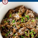 This slow cooker Korean beef is flank steak simmered with soy sauce, sesame oil, brown sugar, garlic and ginger in a crock pot.