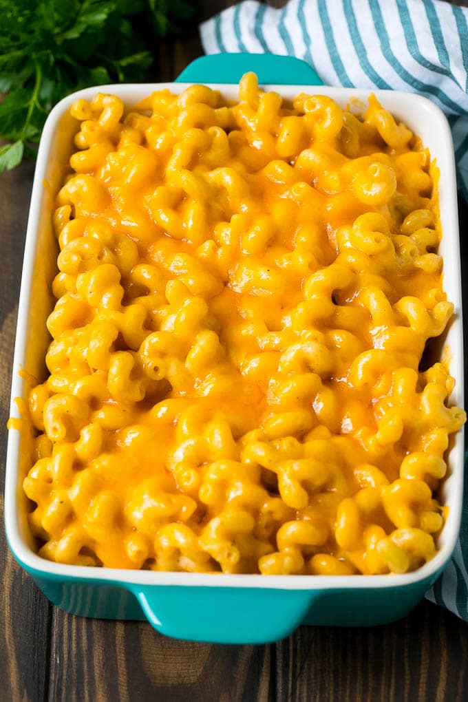 This baked mac and cheese is a blend of tender noodles in a rich and creamy cheese sauce. Baked mac and cheese in a blue casserole dish.