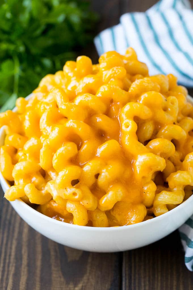 This baked mac and cheese is a blend of tender noodles in a rich and creamy cheese sauce. A bowl of baked macaroni and cheese.