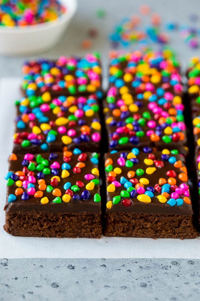 Cosmic Brownies Recipe | Cocoa Brownies | Frosted Brownies #brownies #chocolate #dessert #sadud #sprinkles Cosmic brownies topped with chocolate fudge and crunchy rainbow sprinkles.