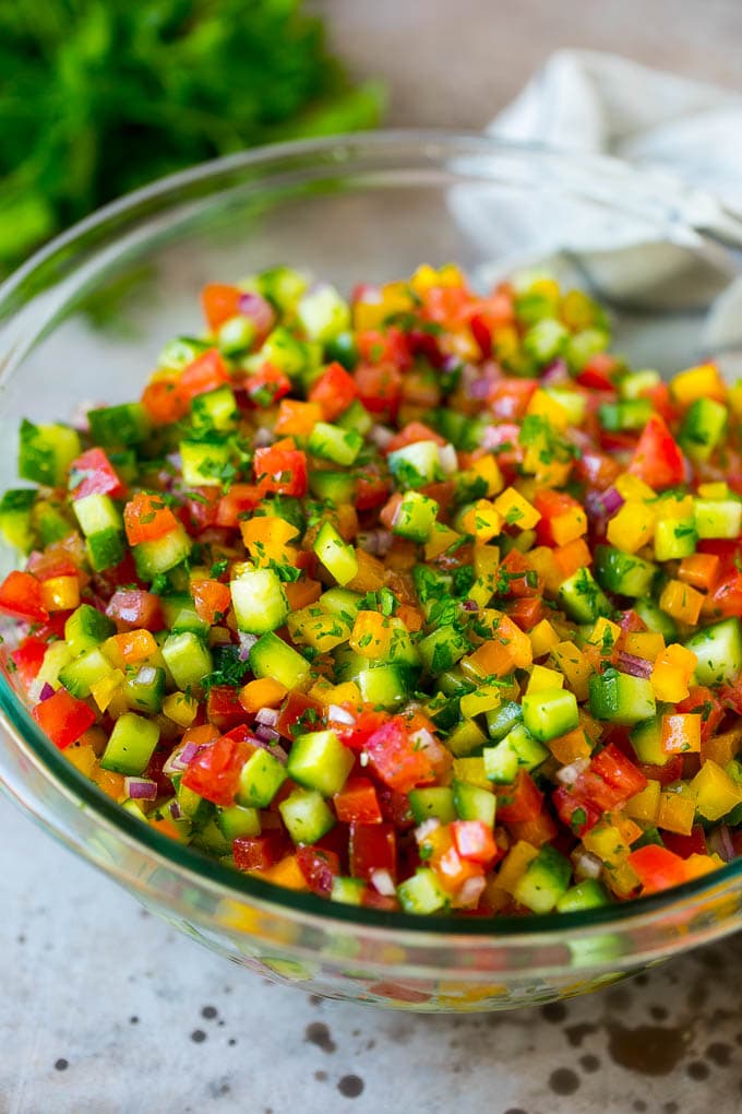 Israeli Salad Recipe | Cucumber Salad | Tomato Salad | Chopped Salad #salad #cleaneating #healthy #glutenfree #lowcarb #keto #sidedish #lunch #sadud Israeli salad with cucumbers and tomatoes in a serving bowl.