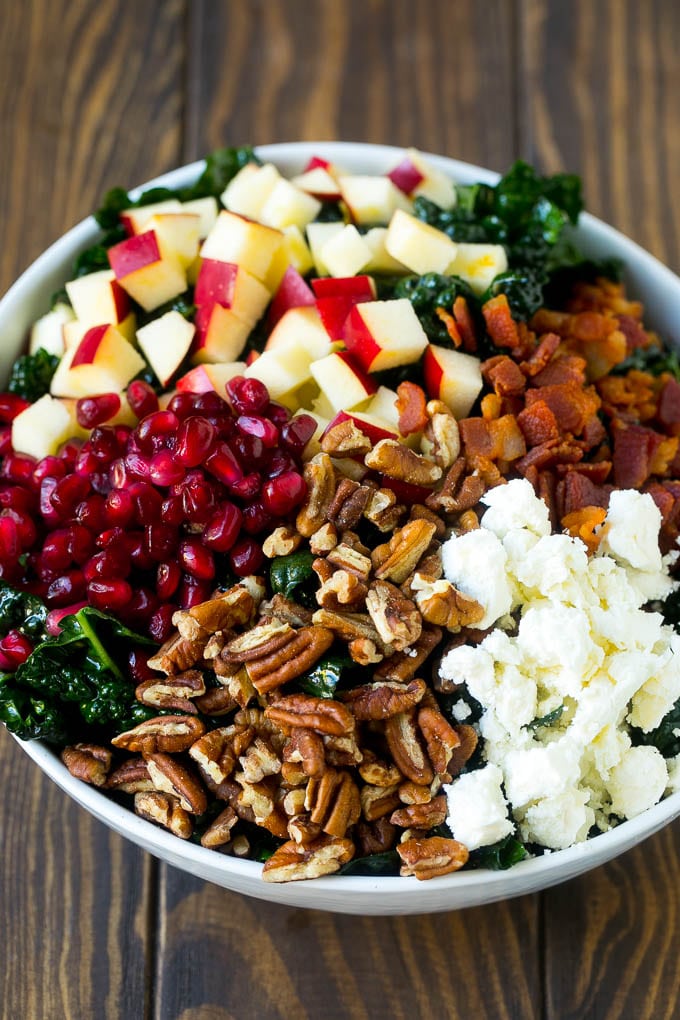 Apple Kale Salad Recipe | Kale Recipe | Fall Salad #kale #apples #bacon #salad #feta #dinner #lunch #sadud Kale salad topped with apples, bacon, pecans, pomegranate and feta cheese.