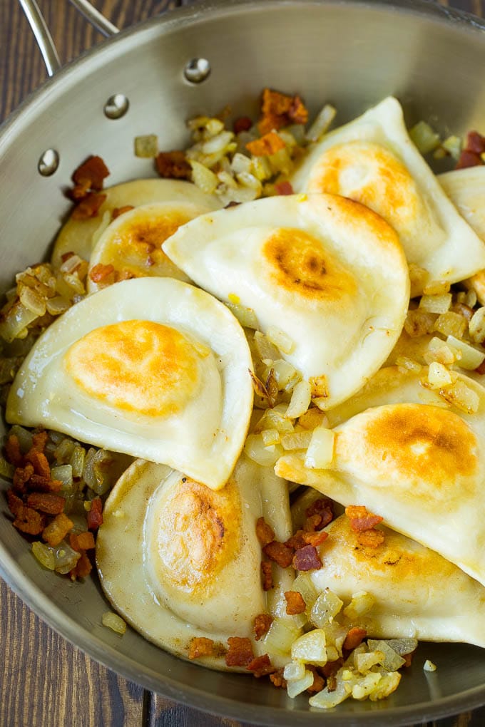 Pierogi Casserole Recipe | Potato Casserole #pierogis #casserole #bacon #cheddar #dinner #sadud Sauteed pierogis with bacon and onions in a skillet.
