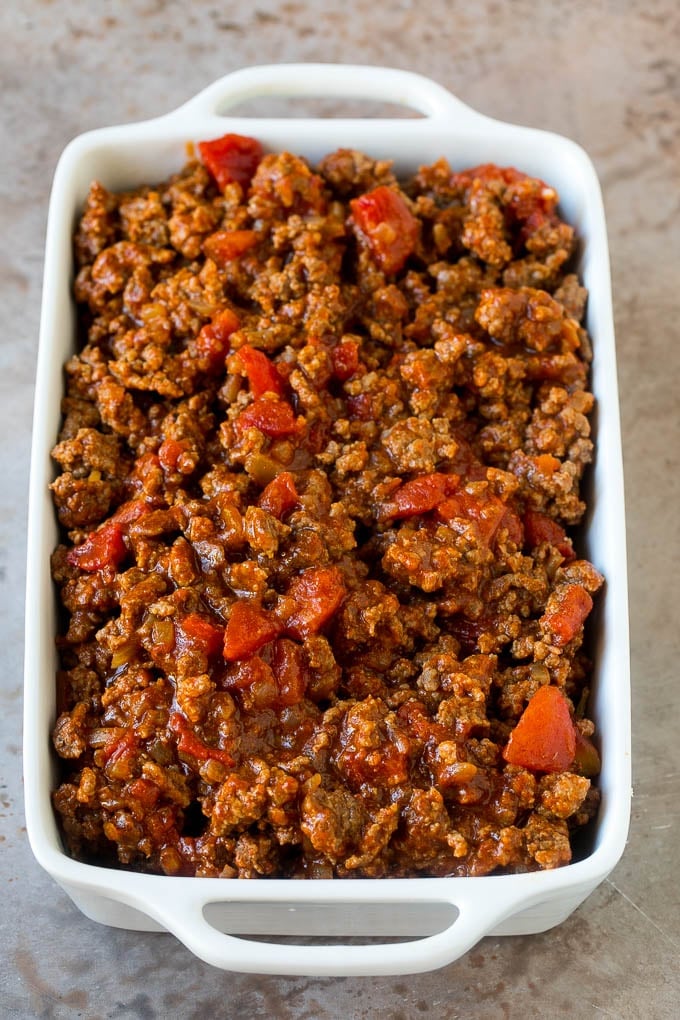 Taco Casserole Recipe | Mexican Casserole | Beef Casserole #casserole #tacos #beef #dinner #cheese #sadud Cooked taco meat in a casserole dish.