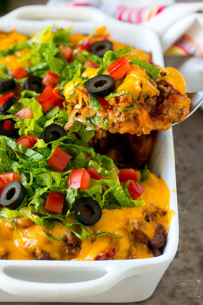 Taco Casserole Recipe | Mexican Casserole | Beef Casserole #casserole #tacos #beef #dinner #cheese #sadud A spoon serving up a portion of beef taco casserole.