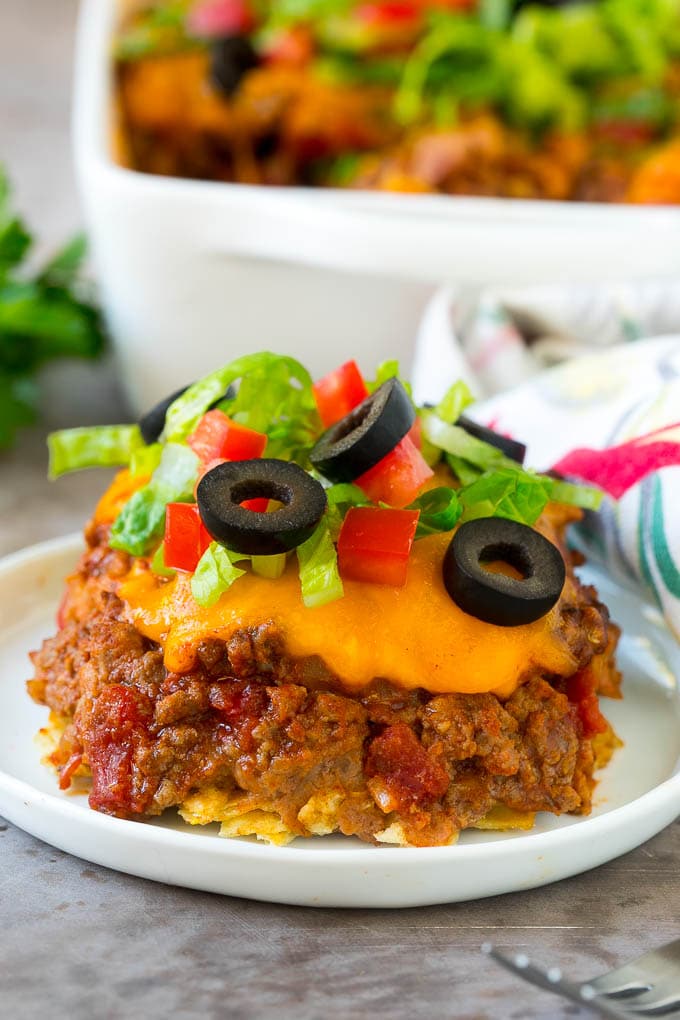 Taco Casserole Recipe | Mexican Casserole | Beef Casserole #casserole #tacos #beef #dinner #cheese #sadud A serving of taco casserole topped with melted cheese.