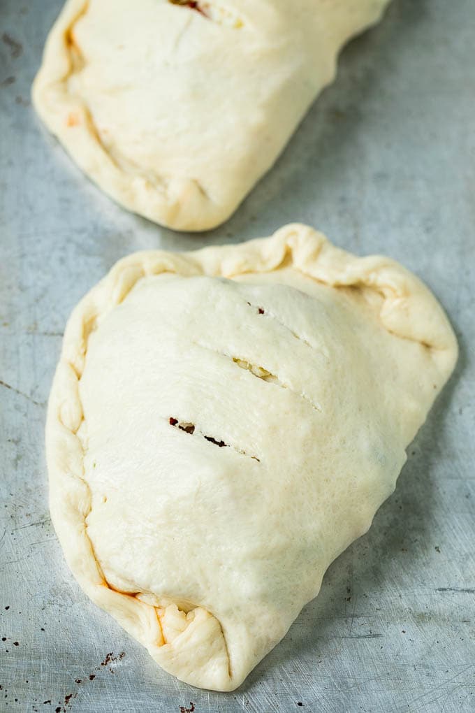 Calzone Recipe | Pizza Pockets #pizza #calzone #pepperoni #sausage #peppers #dinner #sadud #cheese Unbaked calzones ready to go into the oven.
