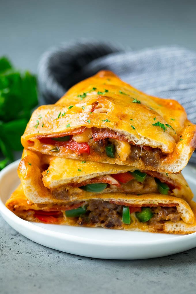 Calzone Recipe | Pizza Pockets #pizza #calzone #pepperoni #sausage #peppers #dinner #sadud #cheese Calzone halves stuffed with sausage, peppers, cheese and pepperoni.