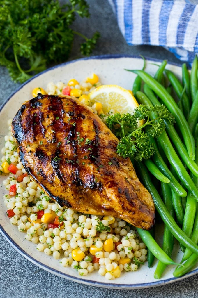 The best chicken marinade produces tender and juicy results every time! Grilled chicken flavored with chicken marinade served with couscous and green beans.
