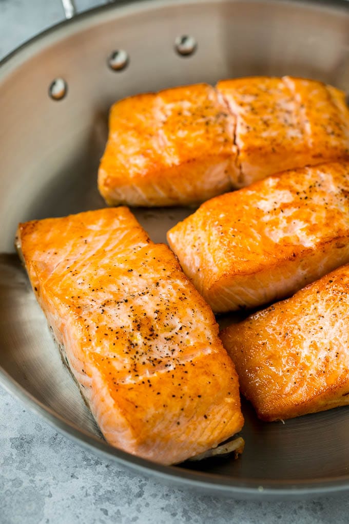 Pan Seared Salmon Recipe | Garlic Butter Salmon | Seared Salmon #salmon #garlic #butter #keto #lowcarb #dinner #sadud Sauteed salmon fillets in a metal skillet.