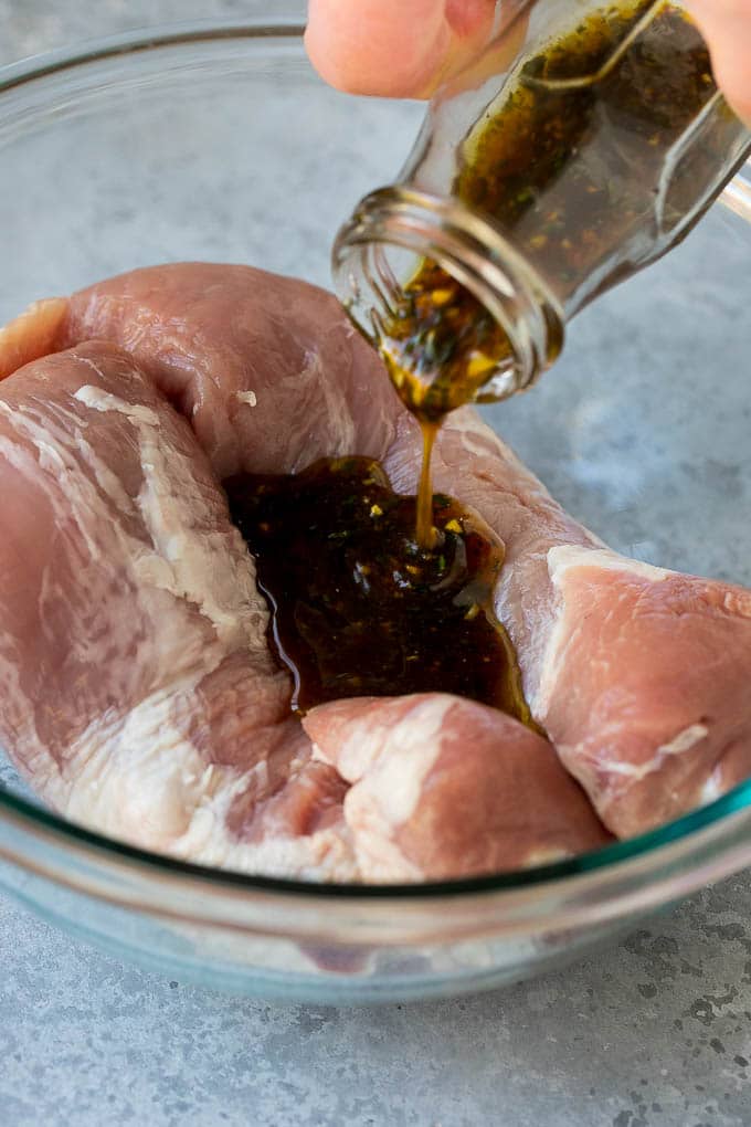 Marinated Pork Tenderloin Recipe | Pork Tenderloin Marinade | Pork Marinade #pork #porktenderloin #marinade #dinner #grilling #sadud Marinade being poured over pork tenderloin.