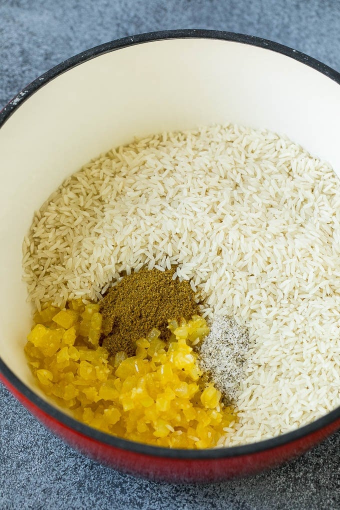 Black Beans and Rice Recipe | Cuban Black Beans | Beans and Rice #beans #rice #blackbeans #sidedish #glutenfree #dinner #sadud Onions, garlic, white rice and spices in a pot.