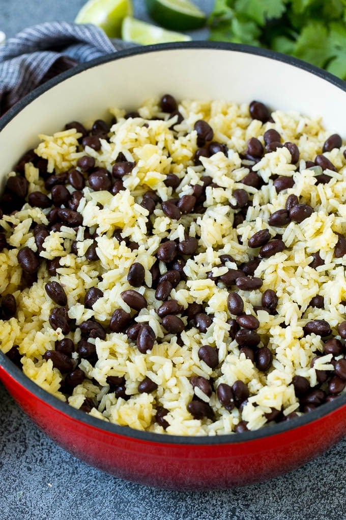 Black Beans and Rice Recipe | Cuban Black Beans | Beans and Rice #beans #rice #blackbeans #sidedish #glutenfree #dinner #sadud Rice and beans mixed together in a red pot.