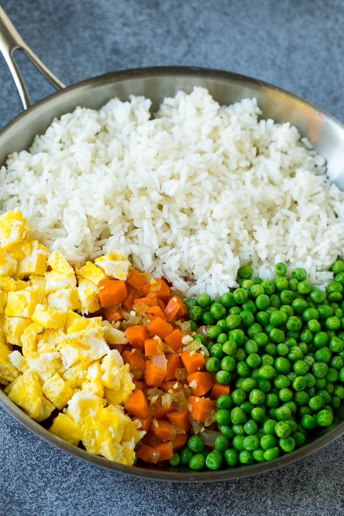 Chicken Fried Rice Recipe | Chinese Fried Rice #rice #chicken #peas #carrots #sidedish #dinner #sadud A pan of cooked rice, carrots, eggs and peas.