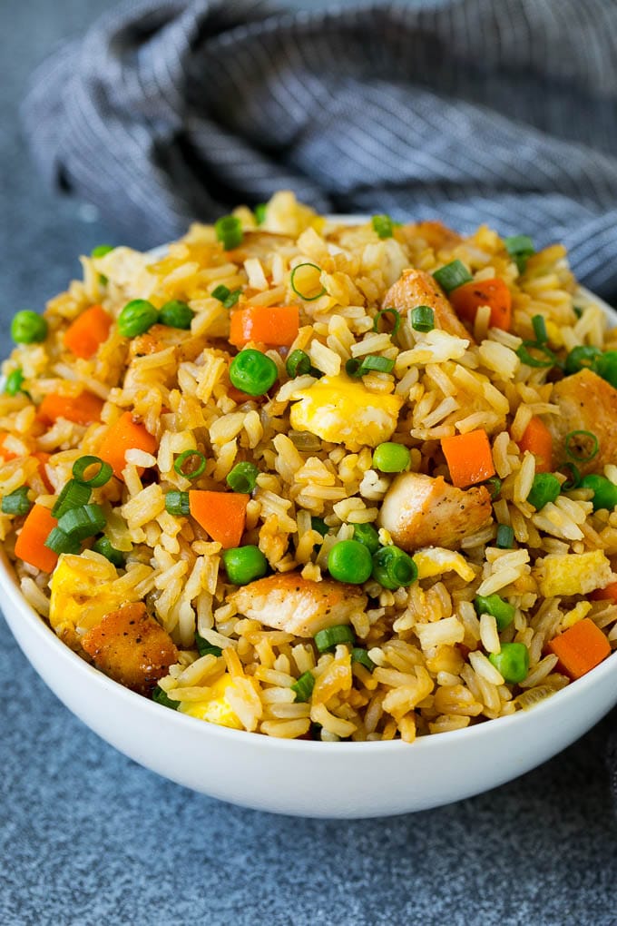 Chicken Fried Rice Recipe | Chinese Fried Rice #rice #chicken #peas #carrots #sidedish #dinner #sadud A bowl of chicken fried rice topped with sliced green onions.