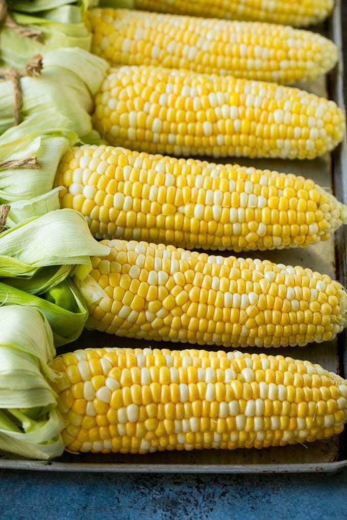 Grilled Corn on the Cob Recipe | Corn Recipe #corn #grilling #summer #sidedish #dinner #sadud Corn cobs on a sheet pan.