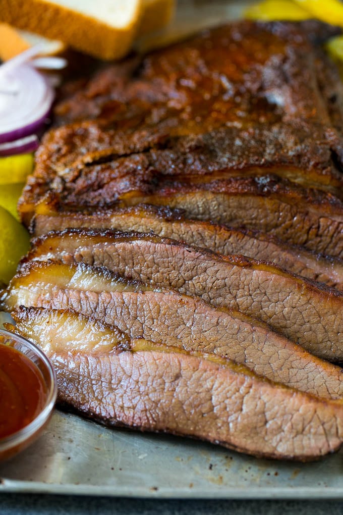 Smoked Brisket Recipe | Beef Brisket | BBQ Beef #brisket #smoker #beef #bbq #dinner #sadud Sliced smoked brisket with a side of BBQ sauce.