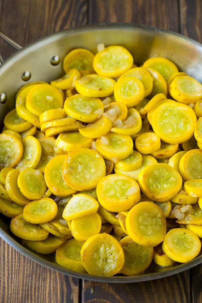 Squash Casserole Recipe | Vegetable Casserole | Zucchini Casserole #casserole #squash #zucchini #cheese #sidedish #sadud Yellow squash and onions in a frying pan.