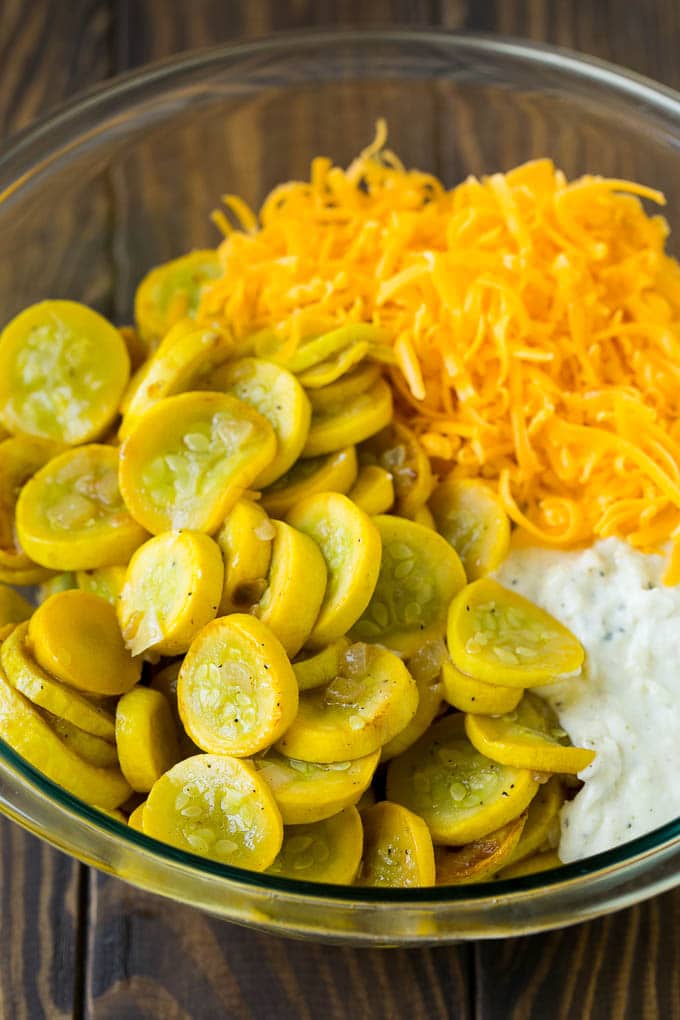Squash Casserole Recipe | Vegetable Casserole | Zucchini Casserole #casserole #squash #zucchini #cheese #sidedish #sadud Cooked yellow squash, creamy sauce and cheddar cheese in a mixing bowl.