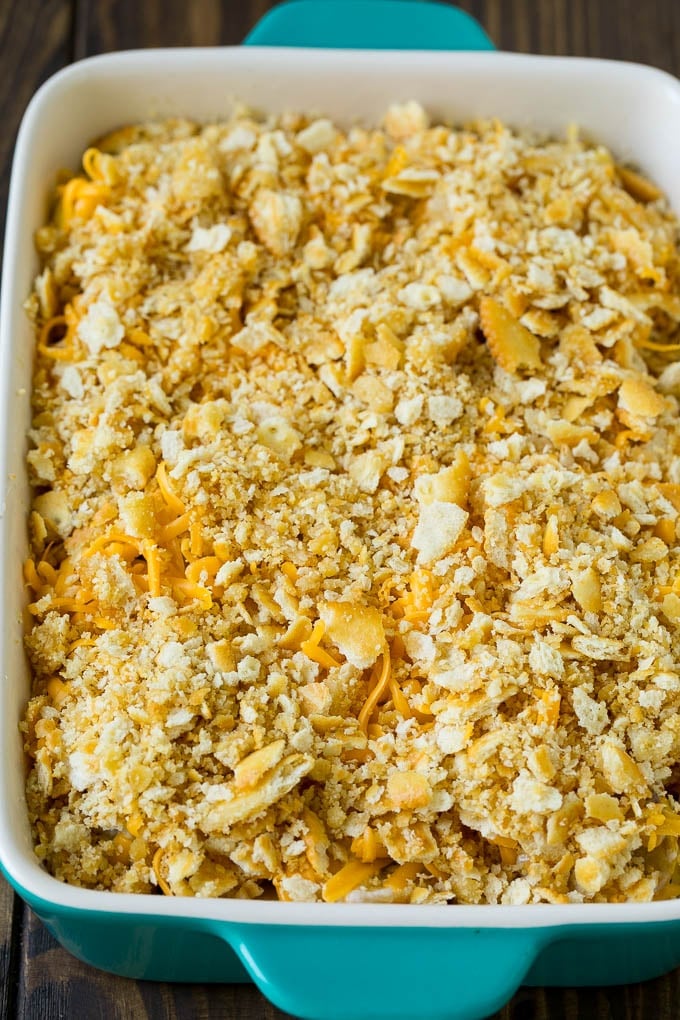 Squash Casserole Recipe | Vegetable Casserole | Zucchini Casserole #casserole #squash #zucchini #cheese #sidedish #sadud Squash in a baking dish topped with cracker crumbs and cheddar cheese.