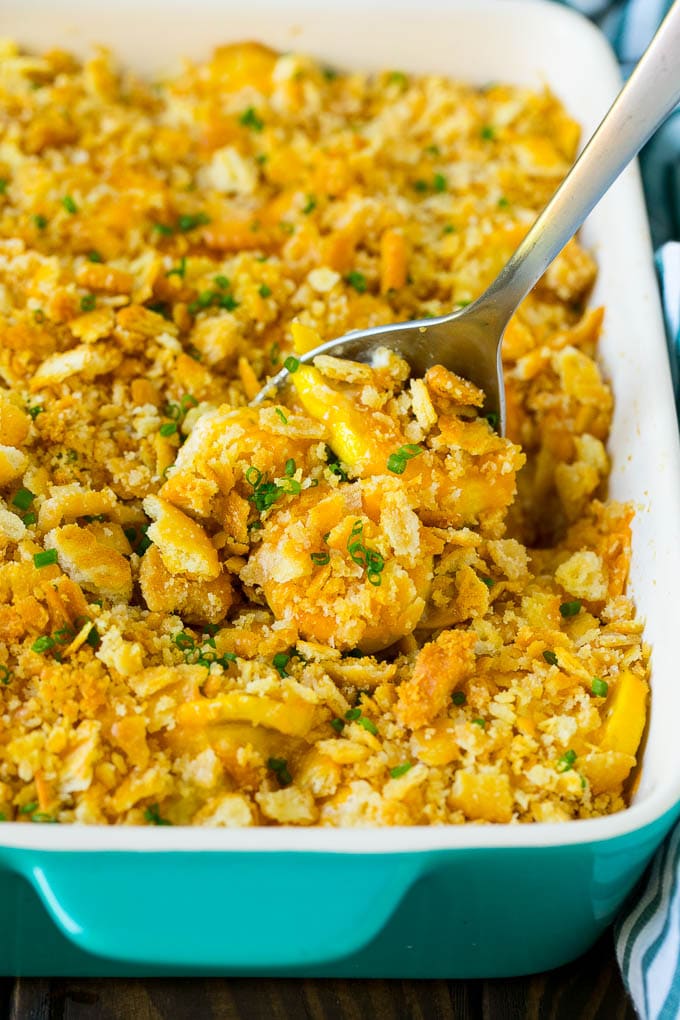 Squash Casserole Recipe | Vegetable Casserole | Zucchini Casserole #casserole #squash #zucchini #cheese #sidedish #sadud A serving spoon in a dish of squash casserole.