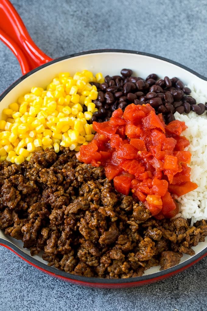 Stuffed Poblano Peppers | Stuffed Peppers | Pasilla Peppers #peppers #stuffedpeppers #beef #rice #beans #corn #dinner #sadud A skillet filled with ground beef, rice, tomatoes, beans and corn.