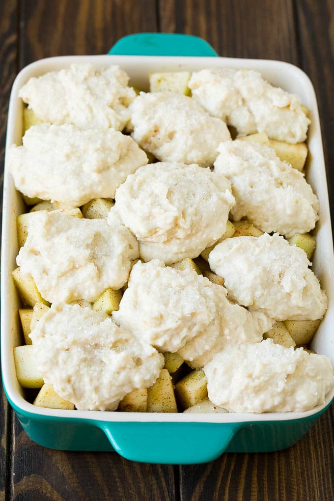 Apple Cobbler Recipe | Apple Dessert #apples #cobbler #dessert #baking #fall #sadud Fruit in a baking dish with dough over the top.