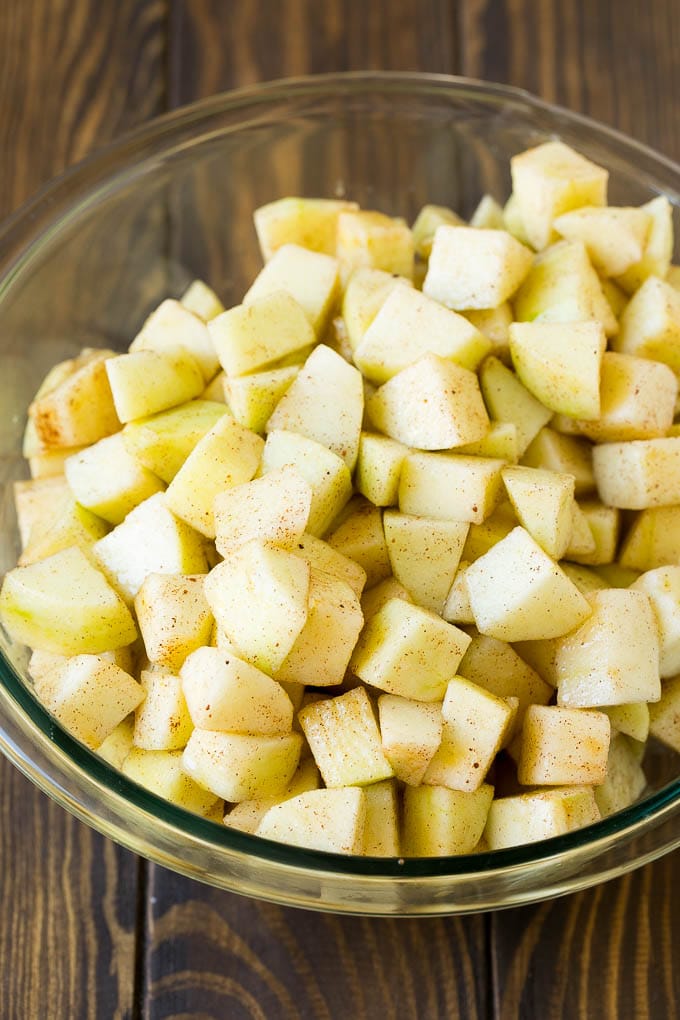 Apple Crisp Recipe | Apple Dessert #apples #dessert #baking #fall #sadud Diced apples tossed with sugar and cinnamon in a bowl.