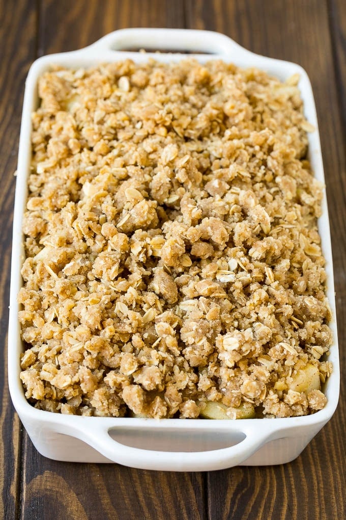 Apple Crisp Recipe | Apple Dessert #apples #dessert #baking #fall #sadud Apples in a baking dish topped with brown sugar crumble.