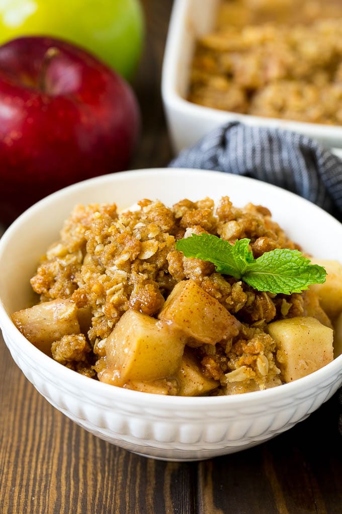 Apple Crisp Recipe | Apple Dessert #apples #dessert #baking #fall #sadud A bowl of apple crisp garnished with a sprig of mint.