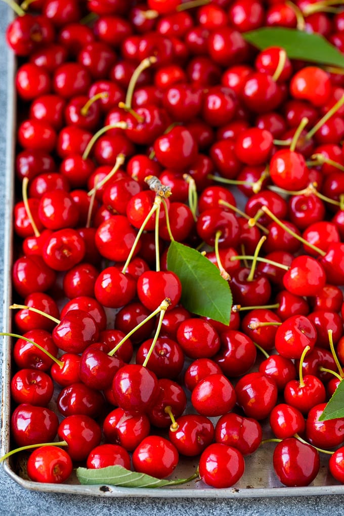 Cherry Pie Filling Recipe #pie #cherries #dessert #sweets #sadud #summer Fresh cherries spread out on a sheet pan.