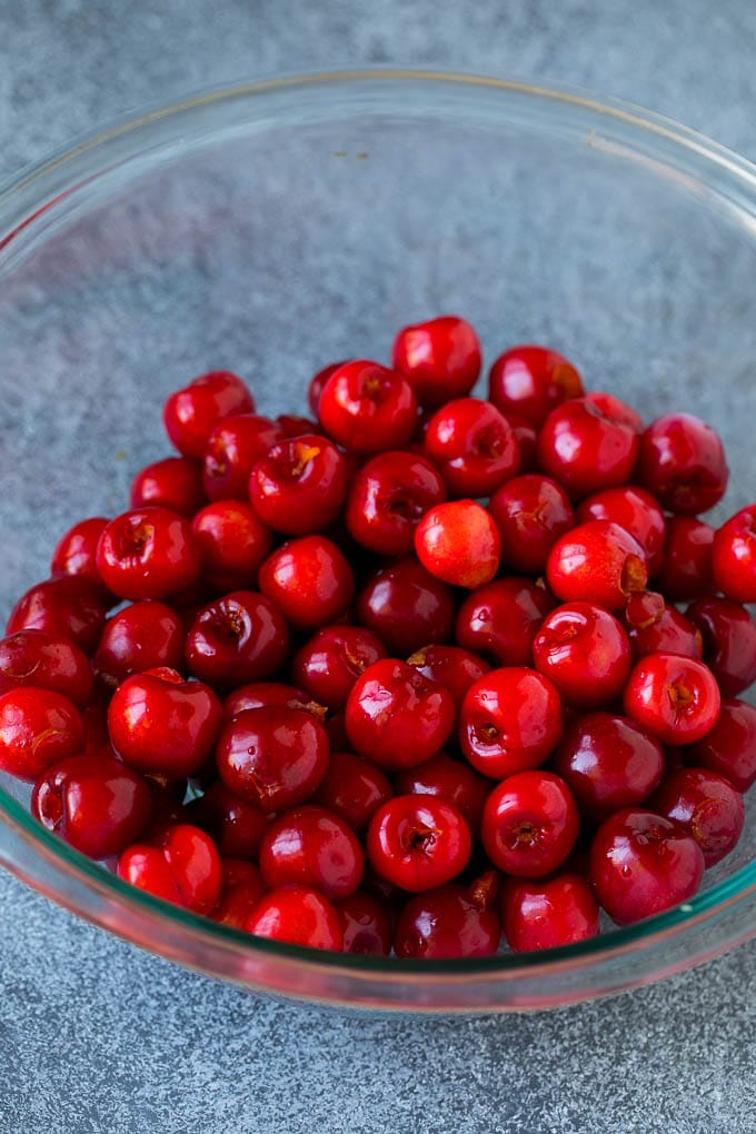 Cherry Pie Filling Recipe #pie #cherries #dessert #sweets #sadud #summer A bowl of pitted cherries.