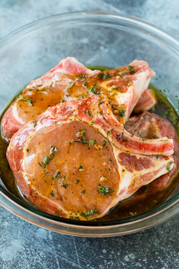 Grilled Pork Chops | Pork Chop Marinade #porkchops #grilling #pork #marinade #dinner #sadud Pork chops in a bowl of marinade.