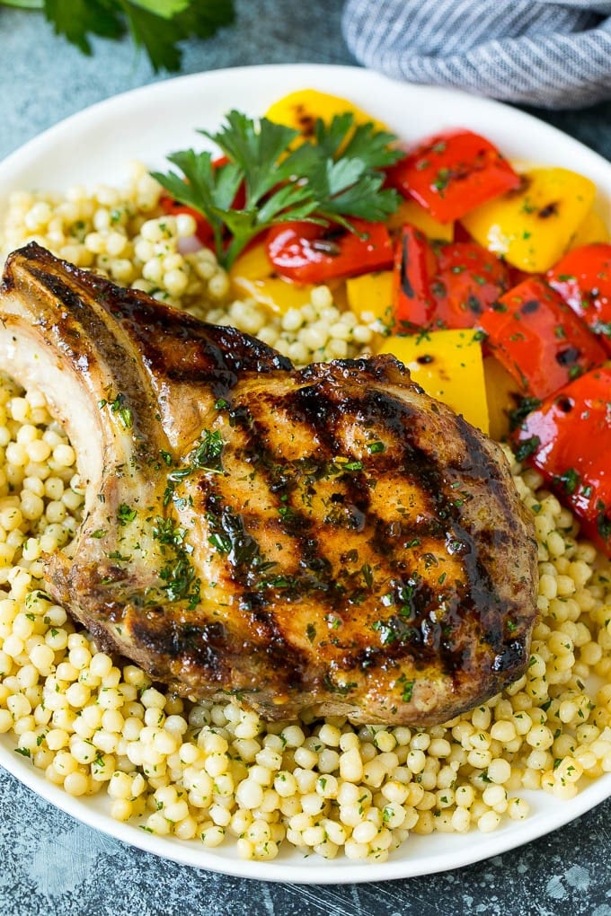 Grilled Pork Chops | Pork Chop Marinade #porkchops #grilling #pork #marinade #dinner #sadud A grilled pork chop served over couscous with bell peppers on the side.
