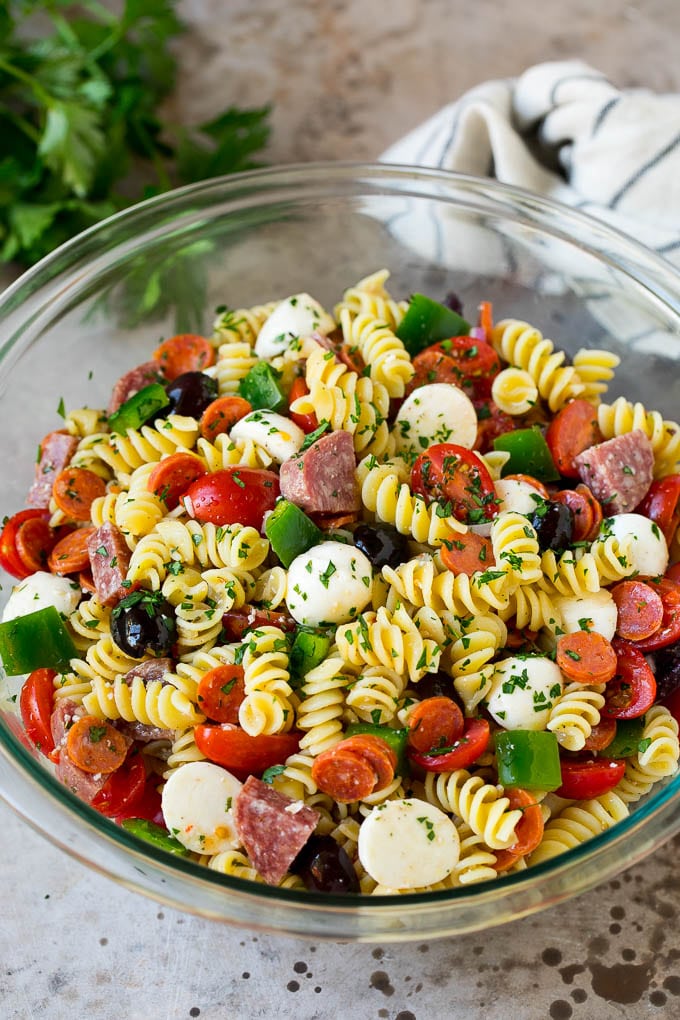 Italian Pasta Salad | Pasta Salad Recipe #pasta #salad #pastasalad #pepperoni #salami #olives #cheese #sidedish #sadud A bowl of Italian pasta salad filled with meats, cheese and vegetables.