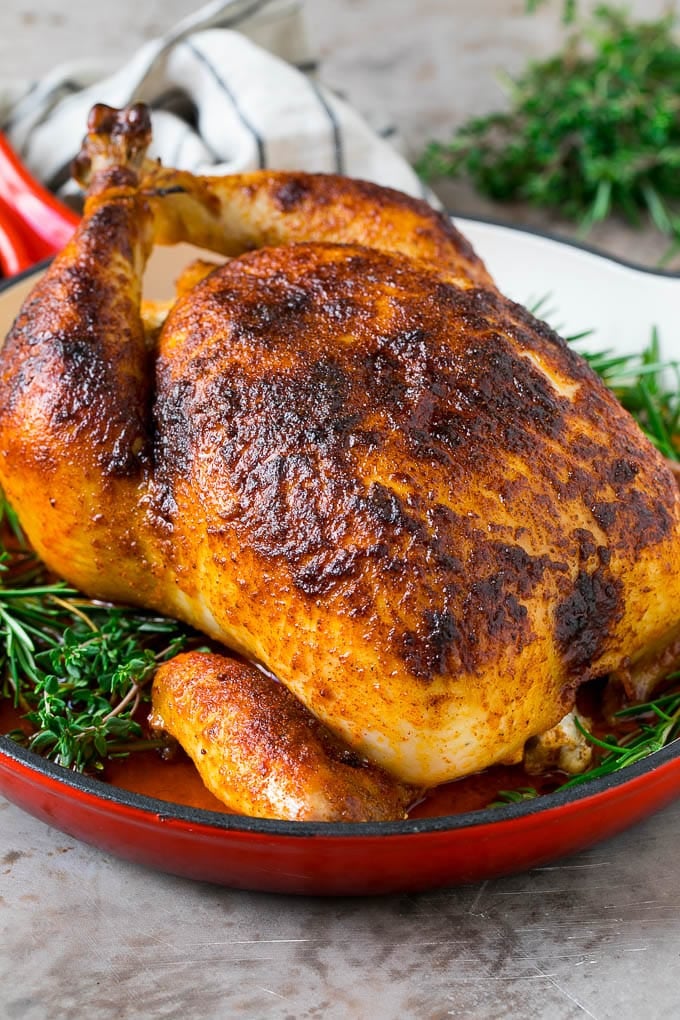 Rotisserie Chicken Recipe | Roasted Chicken #chicken #dinner #sadud #comfortfood Rotisserie chicken in a skillet garnished with fresh herbs.