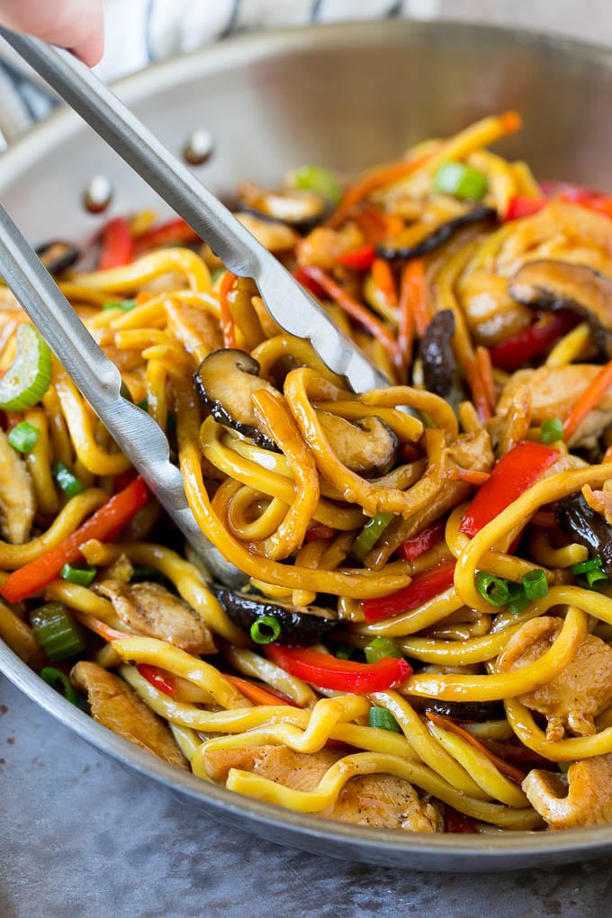 Stir Fry Noodles Recipe | Noodle Stir Fry #chicken #noodles #stirfry #mushrooms #dinner #sadud Tongs serving up a portion of chicken and noodle stir fry.