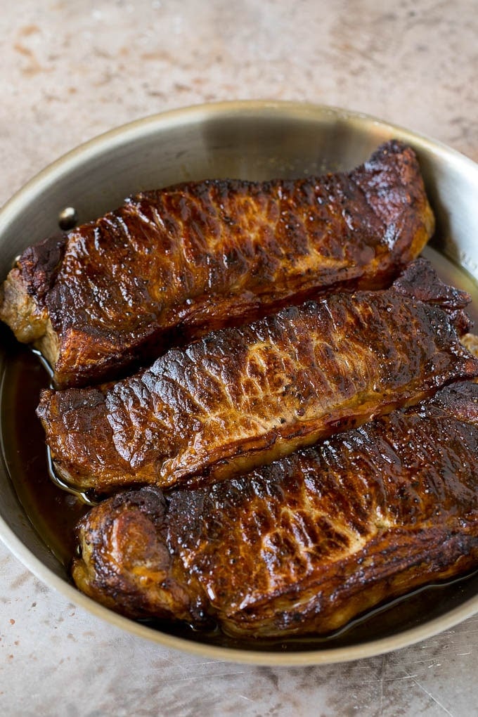 Surf and Turf Recipe | Seared Steak #steak #shrimp #keto #lowcarb #dinner #sadud Seared strip steaks in a skillet.