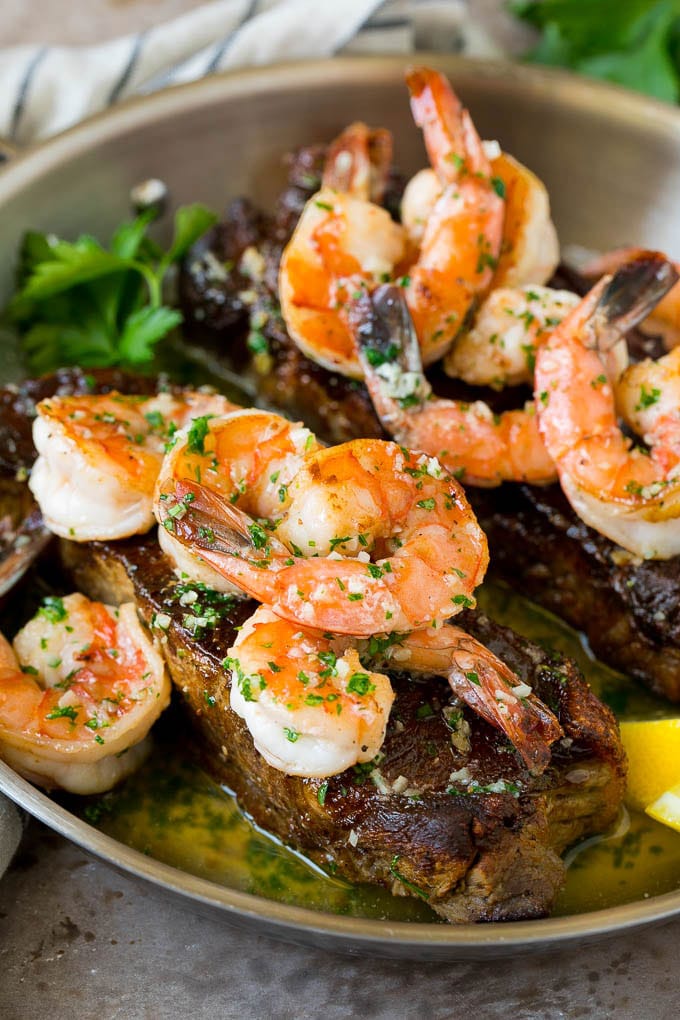 Surf and Turf Recipe | Seared Steak #steak #shrimp #keto #lowcarb #dinner #sadud Surf and turf with seared strip steaks topped with jumbo shrimp in garlic butter.