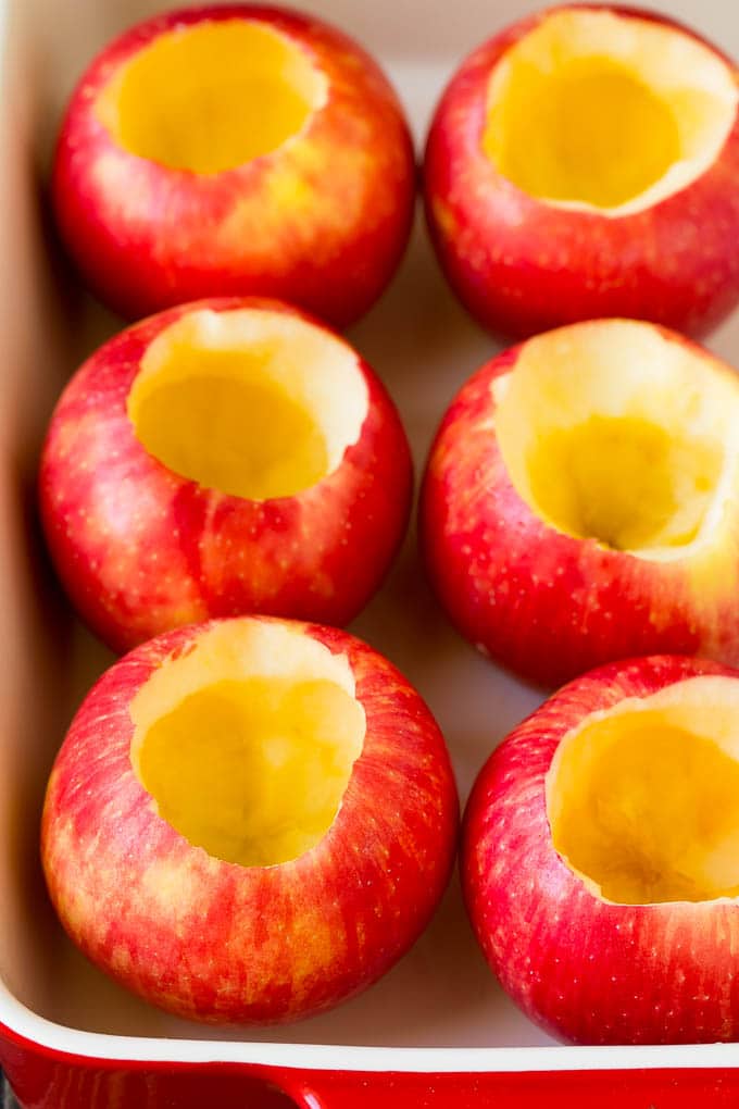 Baked Apples | Stuffed Apples #apples #fall #dessert #sweettooth #sadud Hollowed out apples in a baking dish.