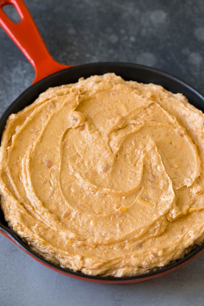 Bean Dip Recipe | Mexican Dip #dip #appetizer #mexicanfood #beans #cheese #sadud Refried frijoles mixed with cream cheese, sour cream and seasonings in a skillet.