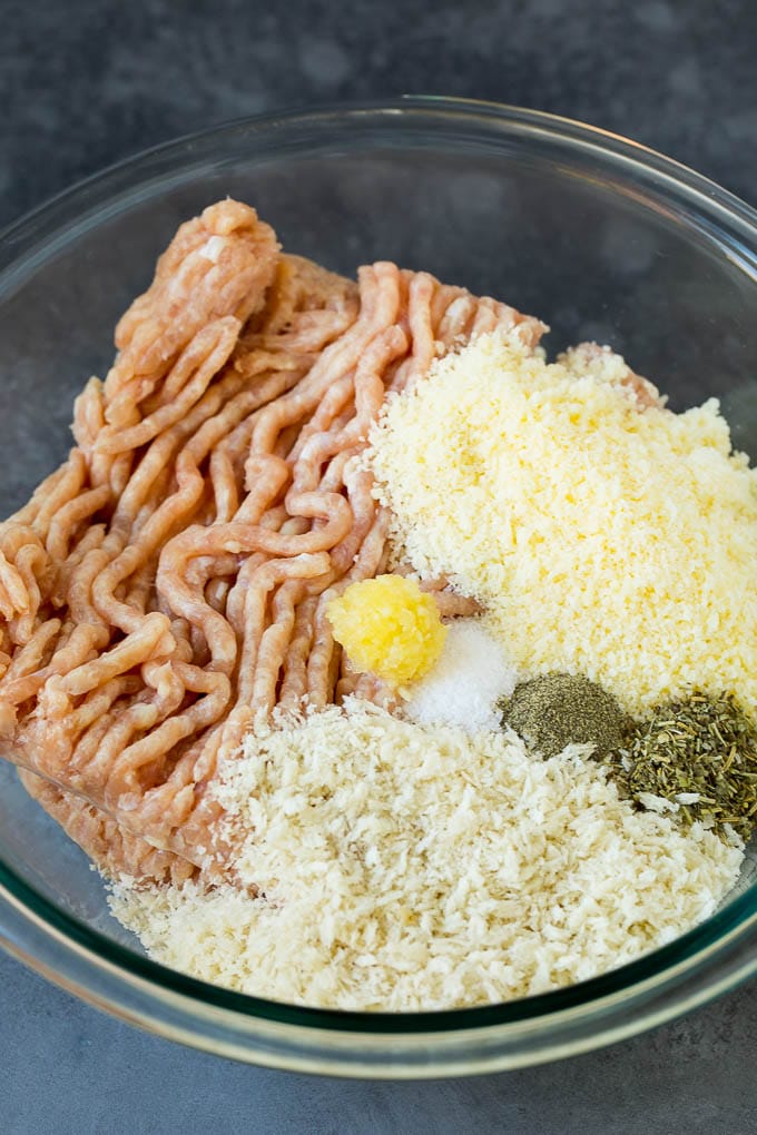 Chicken Meatballs Recipe | Baked Meatballs #chicken #meatballs #dinner #sadud #comfortfood Ground chicken, herbs, breadcrumbs and cheese in a mixing bowl.