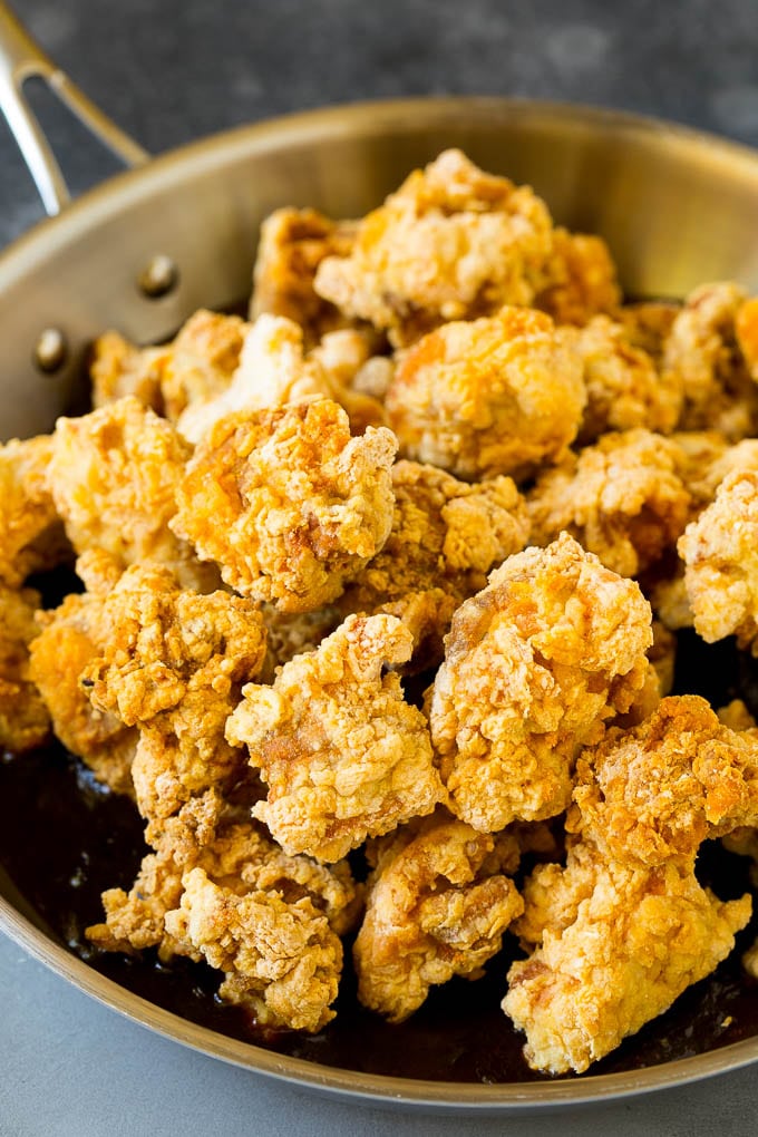 General Tso's Chicken Recipe #chicken #asianfood #dinner #sadud #copycatrecipe Crispy chicken in a skillet filled with savory and spicy sauce.