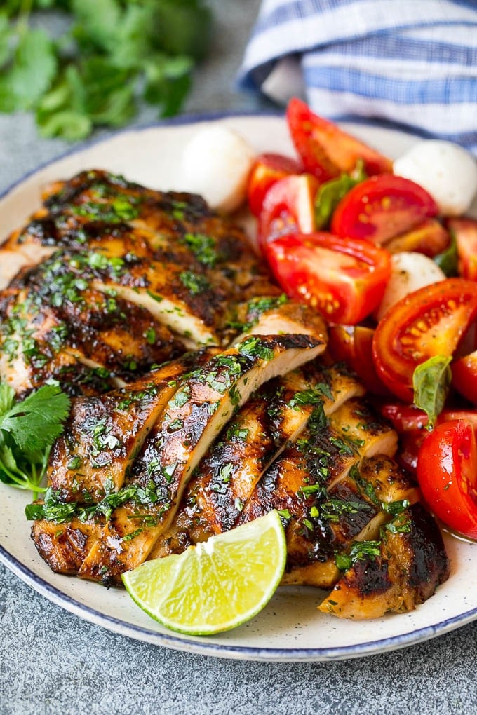 Grilled Chicken Thighs Recipe | Marinated Chicken Thighs #chicken #grilling #marinade #dinner #cilantro #lime #sadud Sliced chicken thighs served with tomato salad.