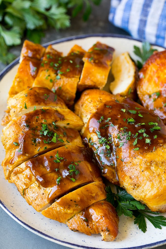 Slow Cooker Chicken Breast Recipe | Crock Pot Chicken Breast | Chicken and Gravy #chicken #slowcooker #crockpot #gravy #dinner #sadud Sliced crock pot chicken breasts on a serving plate.